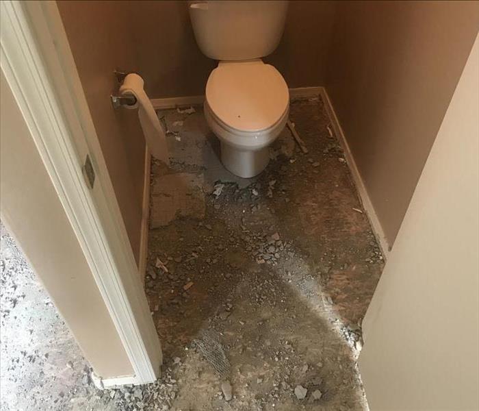Half Bathroom on downstairs floor with flooring pulled out due to water damage