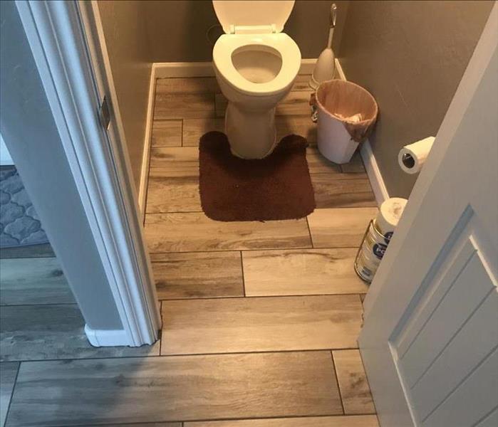 downstairs half bathroom with flooring restored. 